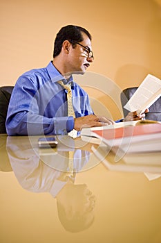 Middle-aged Hispanic businessman working in office