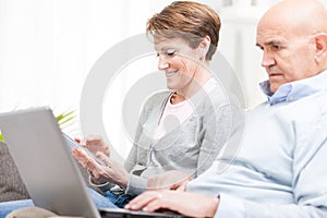 Middle-aged husband and wife surfing the internet