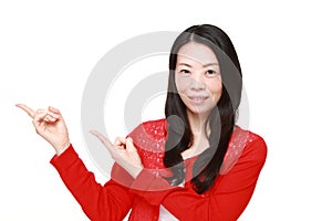 Middle-aged Japanese woman presenting and showing something