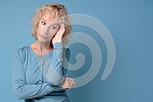 Middle aged lady looking away thinking of loneliness, getting older