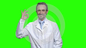 Middle aged male caucasian doctor with ok sign.