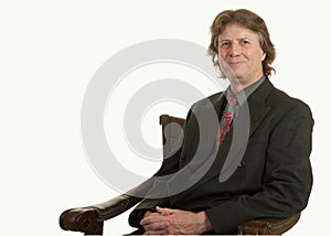 Middle-aged man in armchair on white