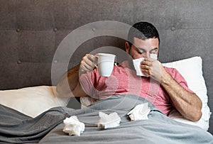 Middle-aged man in bed sick with flu symptoms