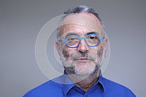 Middle-aged man with blue shirt and glasses