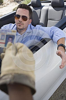 Middle Aged Man In Car Gesturing