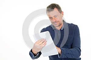 Middle aged man in casual blue shirt using tablet computer over white background