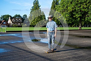 A middle-aged man casually riding on along on a skateboard.