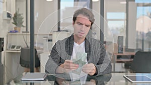 Middle Aged Man Counting Money at Work, Payment