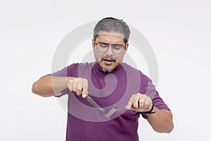 A middle aged man cutting up an imaginary piece of meat with a fork and knife. Pretending to eat. Ready for edit. Isolated on a