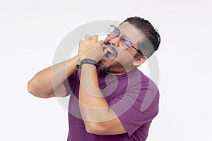 A middle aged man in desperation tries to pull out an aching tooth with his bare hands. Depicting an unbearable toothache.