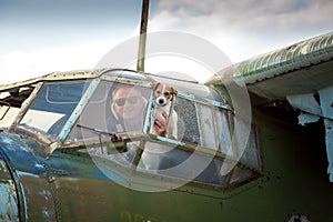 A middle-aged man with a dog aboard an old abandoned Soviet plane.