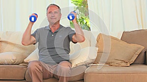 Middle aged man doing exercise of musculation