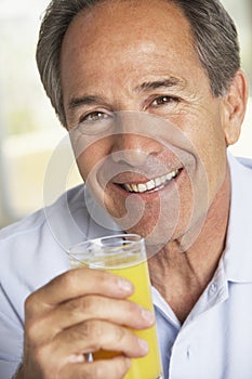 Middle Aged Man Drinking Fresh Orange Juice