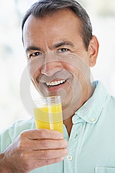 Middle Aged Man Drinking Fresh Orange Juice