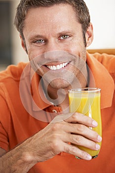 Middle Aged Man Drinking Fresh Orange Juice