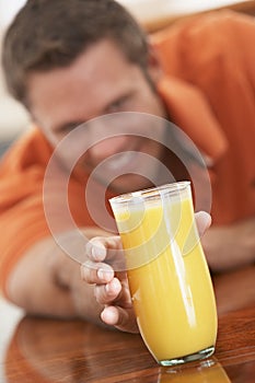 Middle Aged Man Drinking Fresh Orange Juice