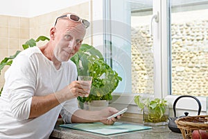 Middle-aged man drinking a glass of juice