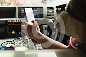 Middle aged man driver using GPS navigation on mobile phone while driving car.