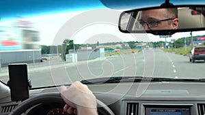 Middle-aged man driving his car in town