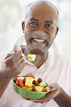 Middle Aged Man Eating Fresh Fruit Salad