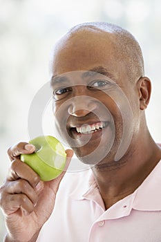 Middle Aged Man Eating Green Apple