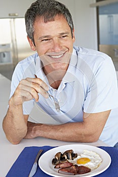 Middle Aged Man Eating Unhealthy Fried Breakfast