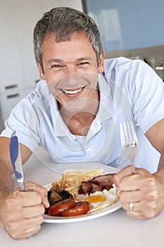 Middle Aged Man Eating Unhealthy Fried Breakfast