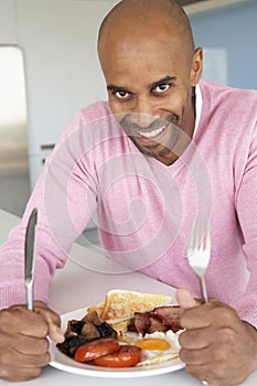 Middle Aged Man Eating Unhealthy Fried Breakfast