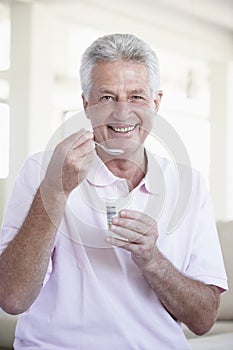 Middle Aged Man Eating Yogurt