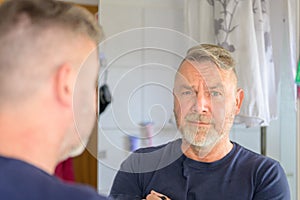 Middle-aged man giving the camera an anguished look photo
