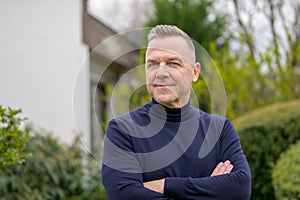Middle-aged man with gray hair in the garden