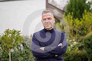 Middle-aged man with gray hair in the garden