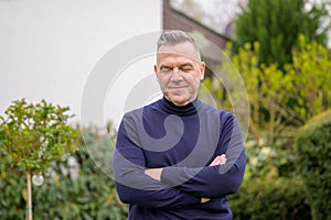 Middle-aged man with gray hair in the garden