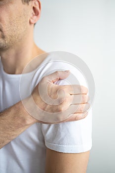 A middle-aged man has shoulder pain on white background.