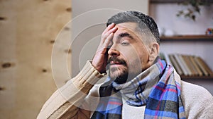 Middle-aged man having terrible headache and fever, feeling sick or hungover