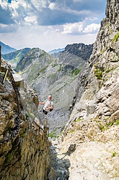 Middle aged man hiking and climbing mountains.