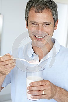 Middle Aged Man Holding Dietary Supplements photo