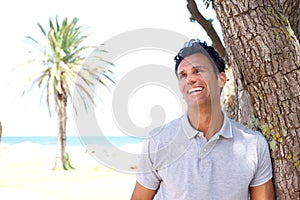 Middle aged man laughing outside in summer