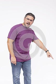 A middle aged man looking puzzled and befuddled while pointing to something below to the right, 45 degree angle. Wearing a purple