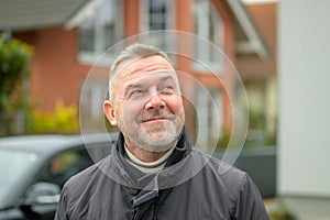 Middle-aged man looking up with an amused smile