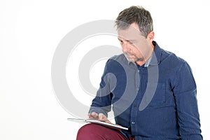 Middle aged man looking using digital tablet computer isolated on white background