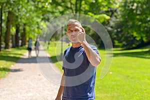 Middle aged man out jogging in a park
