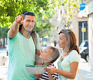 Middle-aged man pointing the direction for family