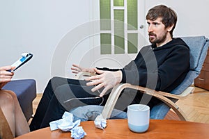 Middle-aged man in a psychologists office for a consultation. Social problems, depression, crisis