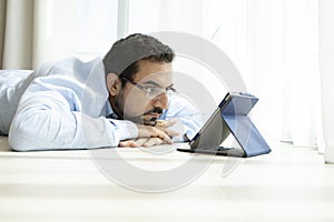 Middle aged man reading a book in e-reader