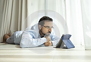 Middle aged man reading a book in e-reader