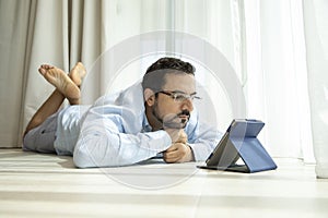 Middle aged man reading a book in e-reader