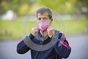 Middle-aged man relaxing wearing a face mask