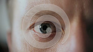 Middle-aged man`s blue-gray eye. Close-up. Macro.European