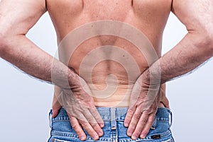 Middle-aged man with severe pain in the lumbar region photo